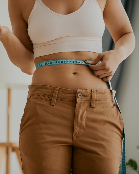 woman measuring waist