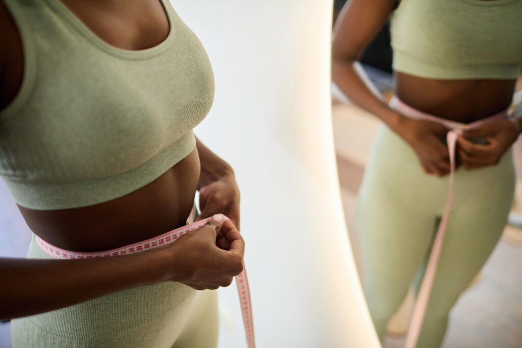 measuring-waistline-during-fitness-routine-2025-06-14-06-37-56-utc (1) (1)