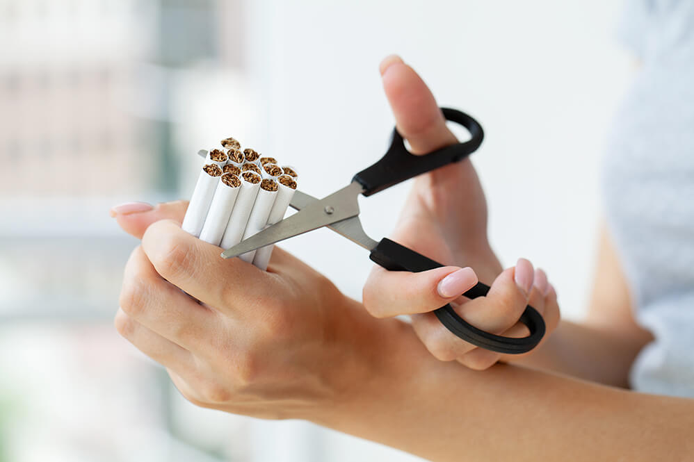 stop-smoking-woman-cuts-a-cigarette-with-scissors-2025-02-12-05-50-49-utc (1)