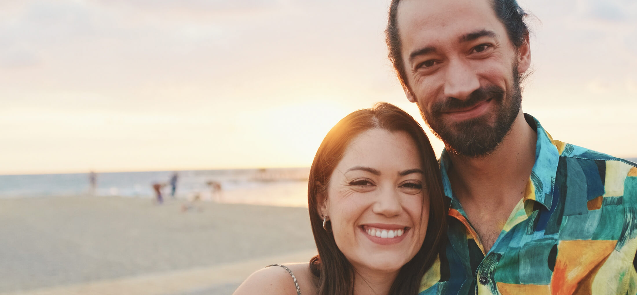 young-couple-standing-on-the-beach-at-sunrise-pan-2025-08-04-01-25-58-utc (1)